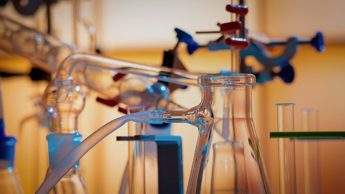 Image of beakers in a laboratory with chemicals in them